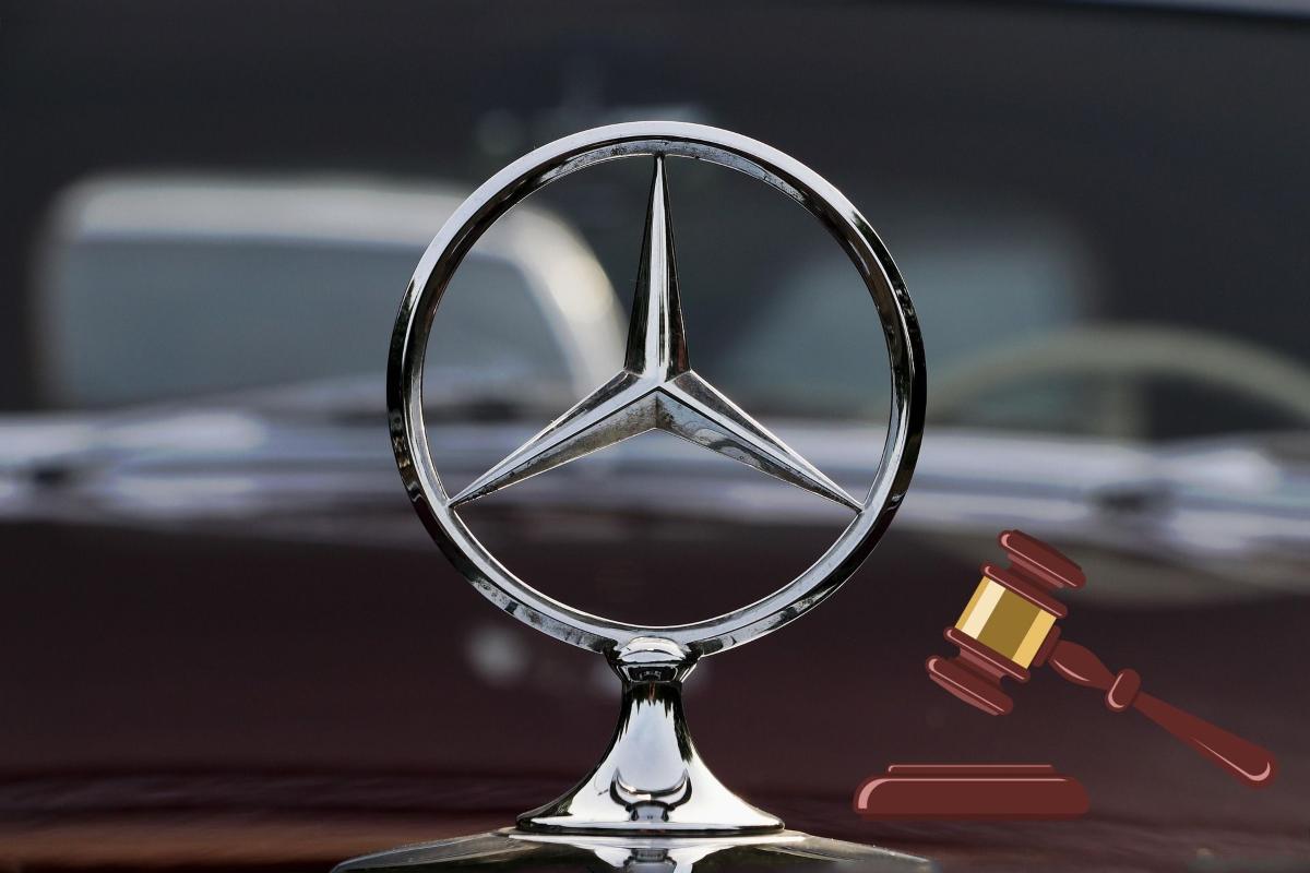 Il logo della Mercedes e a destra il disegno di un martelletto che batte