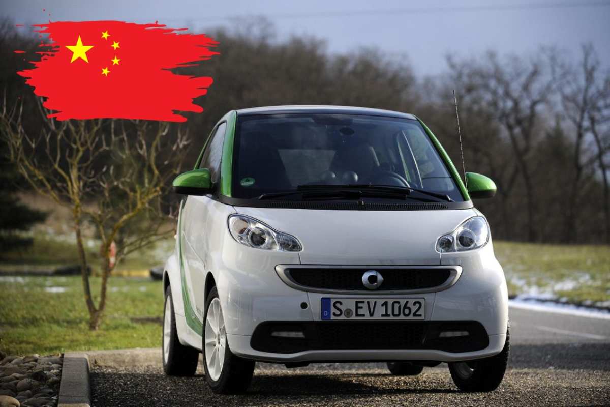 Smart ForTwo in strada e a sinistra la bandiera cinese